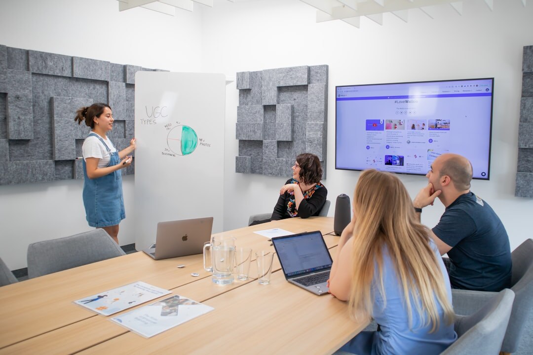Consultant presenting audience data charts on a large screen