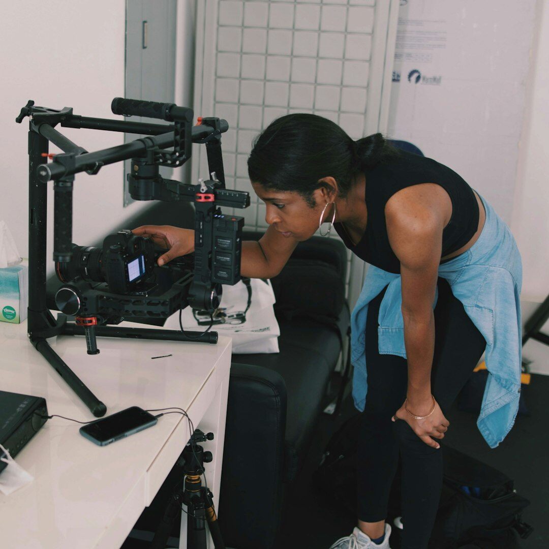 Technician adjusting a professional broadcast camera lens